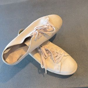 Worn damaged genuine leather sneakers